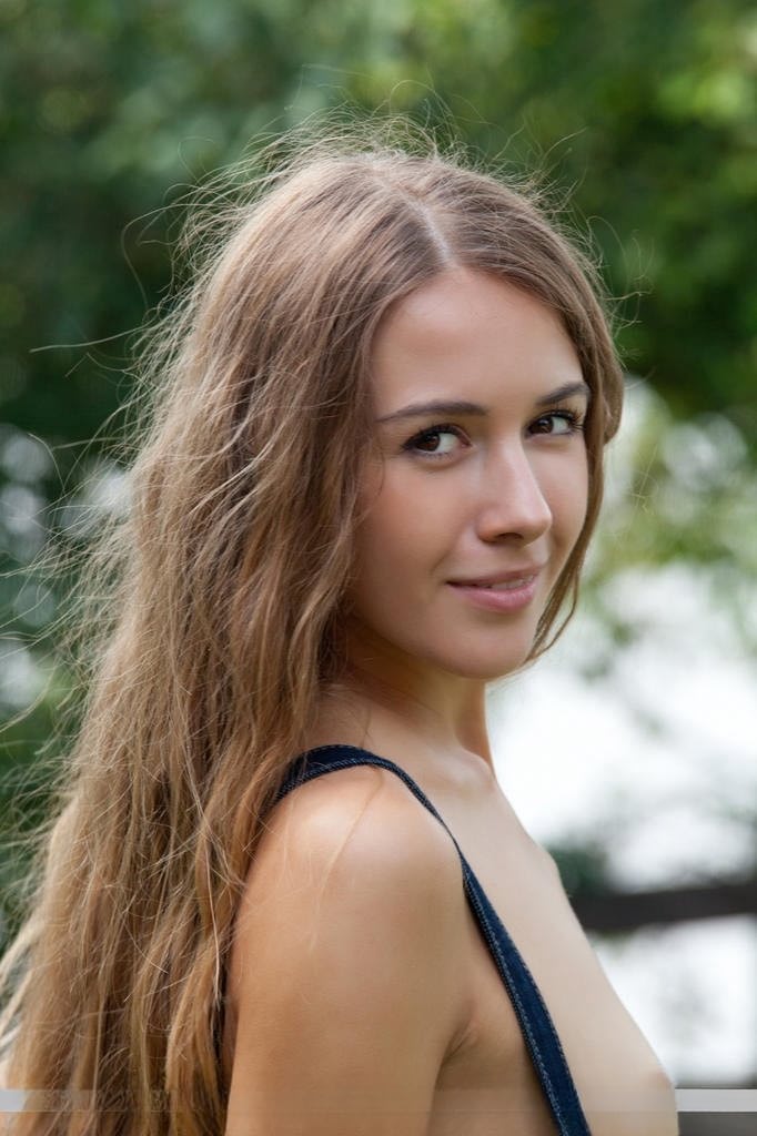 Skinny teen model Lina Diamond removes shorts to pose naked on picnic table