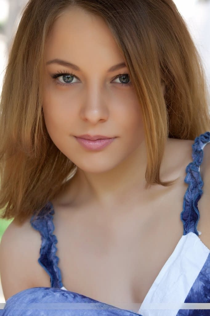 Smiley faced teen Nikia A removing dress for outdoor glamour spread