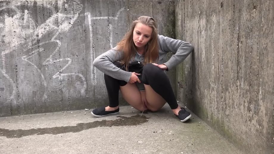 Blonde teen Suzzie baring her pussy lips and sexy ass and pissing in public