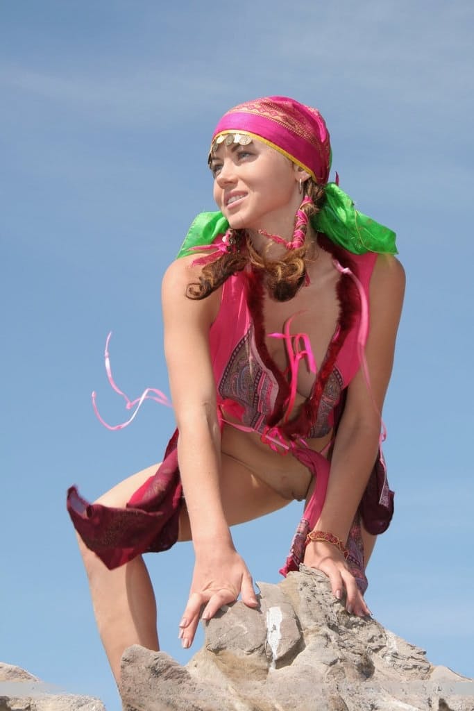 European teen Firebird A posing barefoot on rocky cliffs in revealing outfit