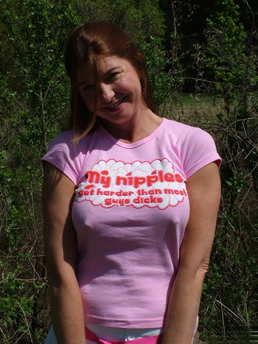 Mature woman Dee Delmar shows off her her large tits in backyard