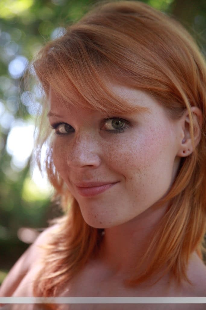 Nude redhead Mia Sollis flaunts her well formed body on cut line in forest
