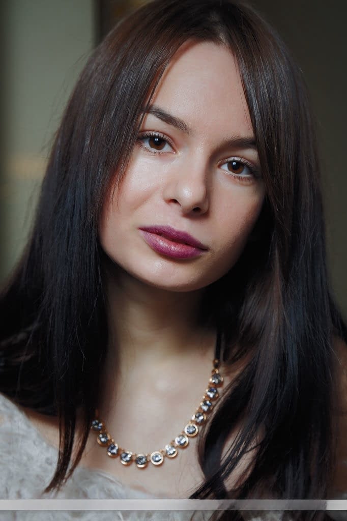 Young brunette model Debora A flashes nice tits and displays her nude pussy