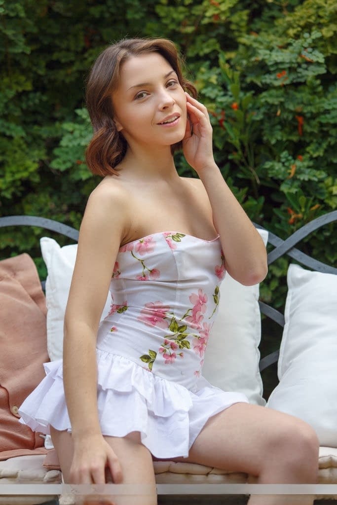 Innocent teen Una Piccola takes off her ruffle dress and underwear on a bench