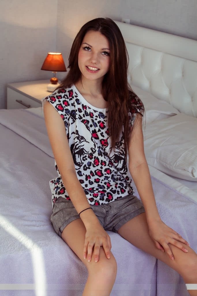 Sweet little Iva strips bare on the bed & flaunts her sexy toes for the camera