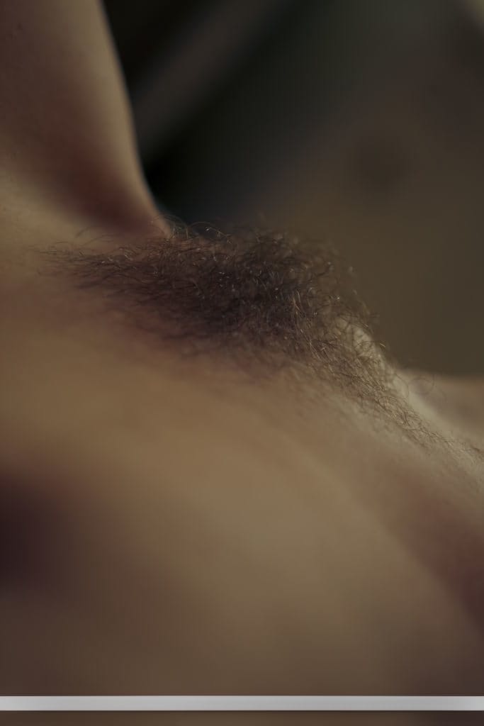 When horny Emily J can't sleep, she masturbates her trimmed naked pussy solo