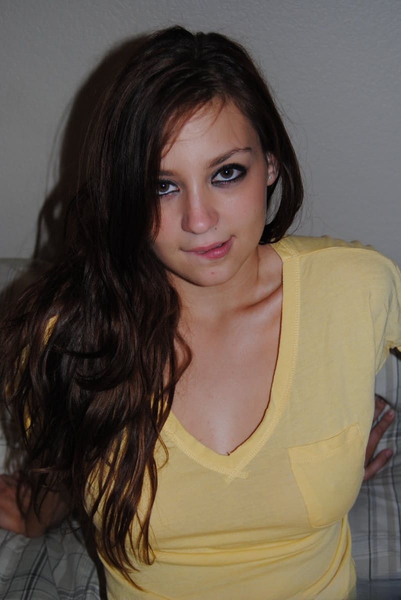 Brunette solo girl with painted toenails exposes her bare boobs