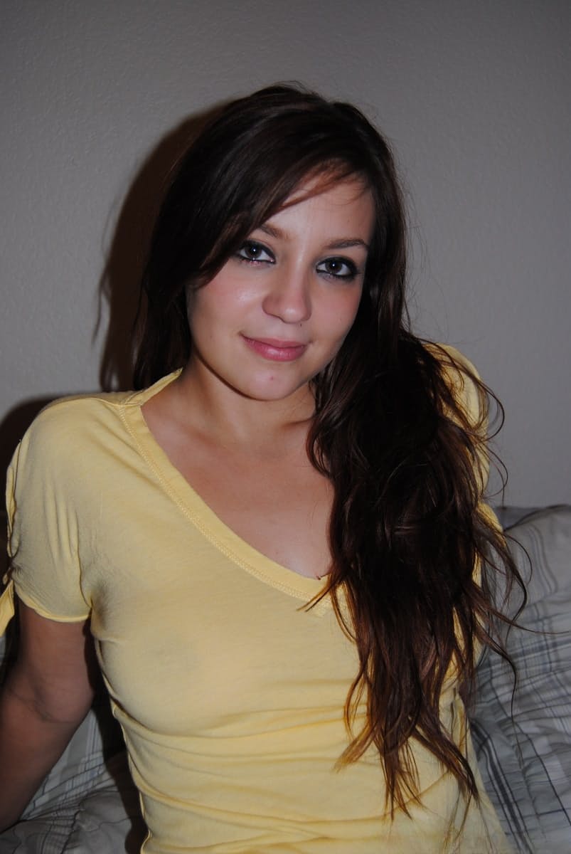 Brunette solo girl with painted toenails exposes her bare boobs