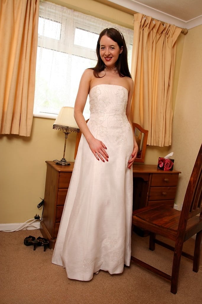 UK housewife dons her wedding dress before spreading her moist pussy