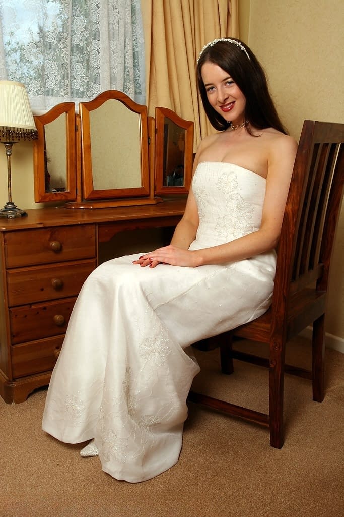 UK housewife dons her wedding dress before spreading her moist pussy