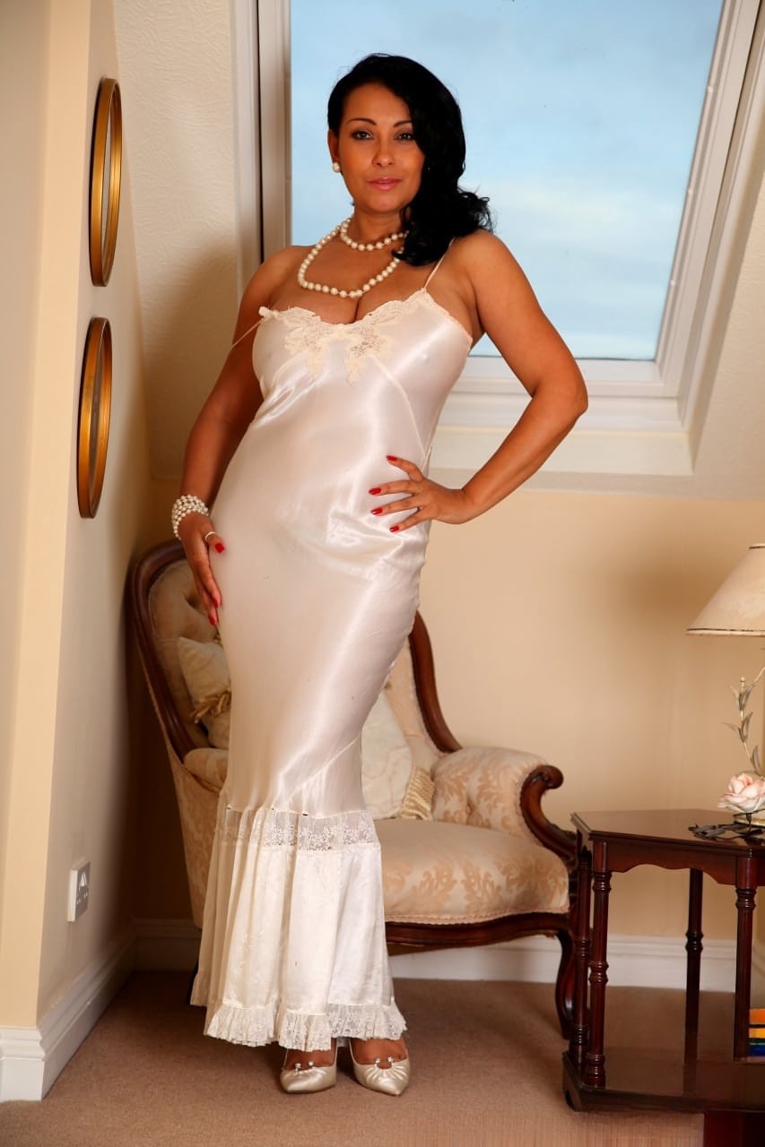 Classy mature lady Danica Collins frees big tits and twat from silk nightdress