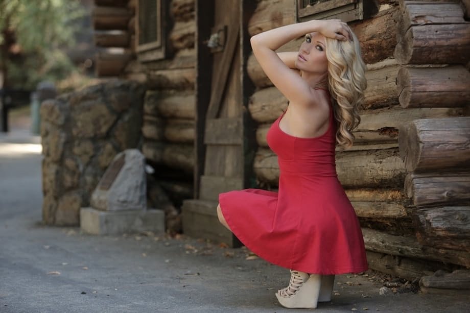 Bare legged blonde Shannyn Xo flashes upskirt panties in front of a log cabin