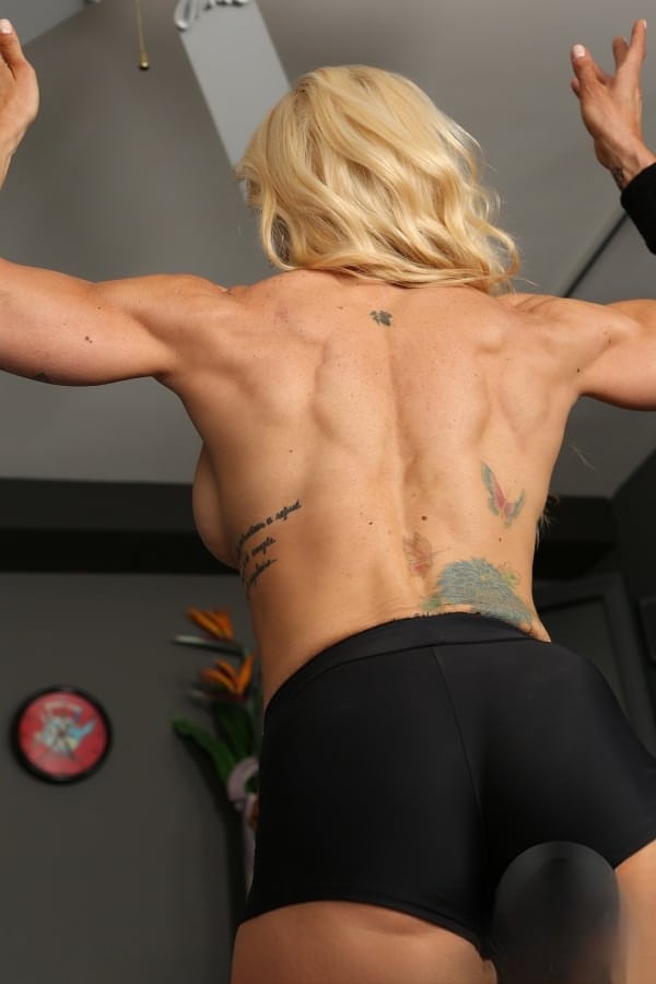 Busty bodybuilder Jill Rudison flexes naked while working out