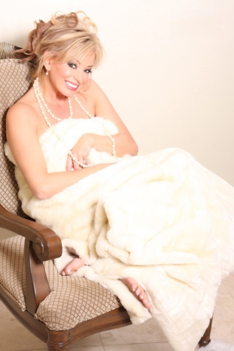 Busty classy mature Rachel Aziani poses naked wearing a string of pearls