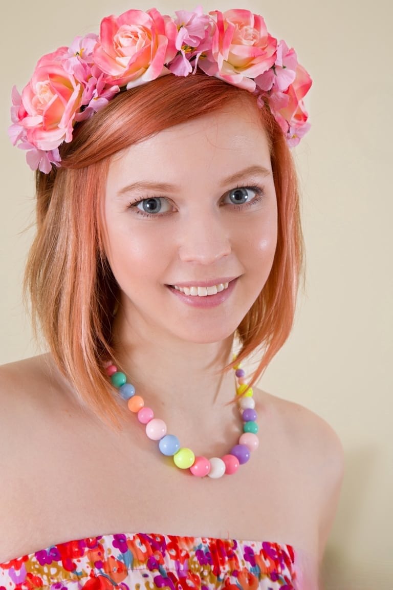 Natural redhead uncovers her perky teen boobs as she strips nake