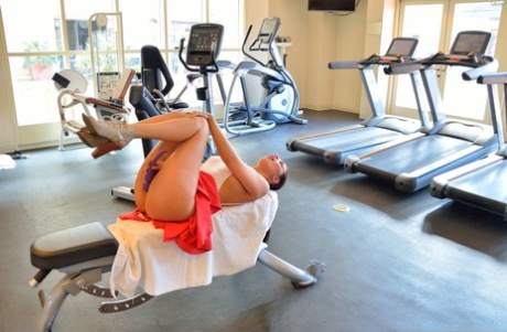 Naughty girl flashes her tits and pussy in lounge and on exercise equipment