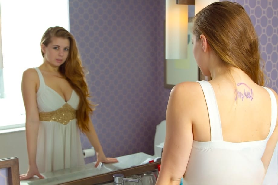 Cute redhead Jessi shedding her sexy lingerie to pose with nice tits bare