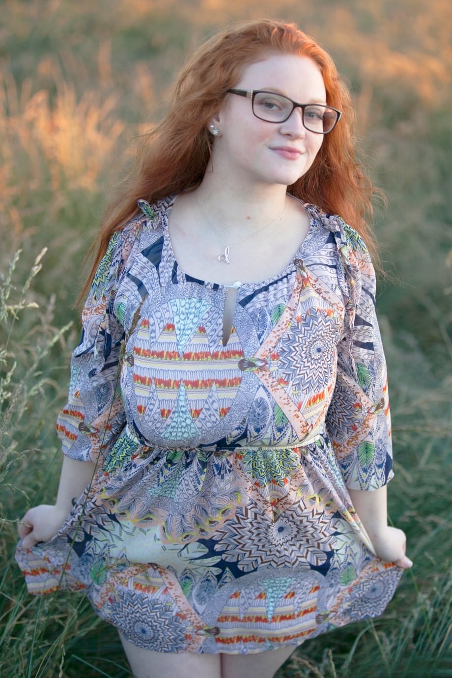 Hot redhead BBW Kaycee looses her huge tits and gets on her knees in a field