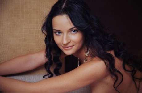 Dark haired solo girl Ardelia A showcases her shaved pussy in the nude
