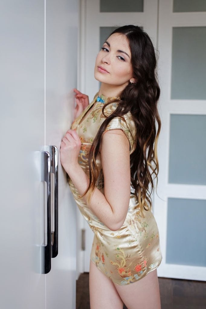 Gorgeous brunette Lukki Lima removes her tight dress to spread her long legs