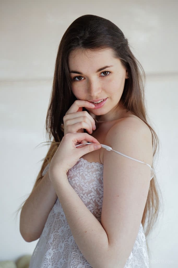 Beautiful young Lukki Lima undressing to finger her shaved pussy to orgasm