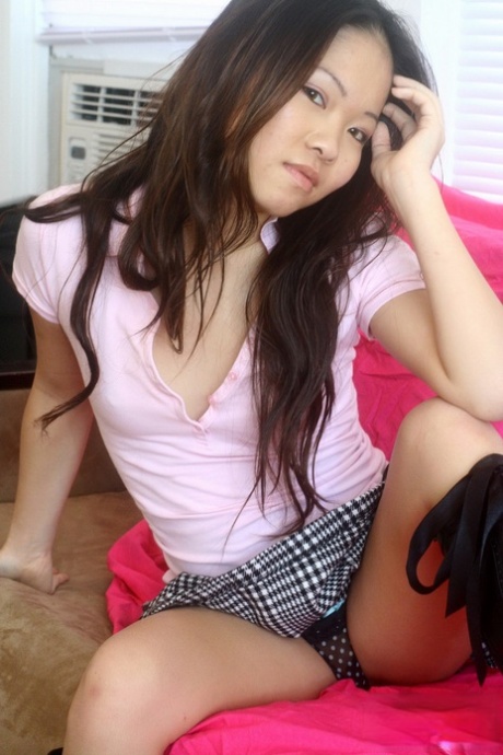 Tiny Asian girlfriend Grace strips short skirt off and poses in a g-string