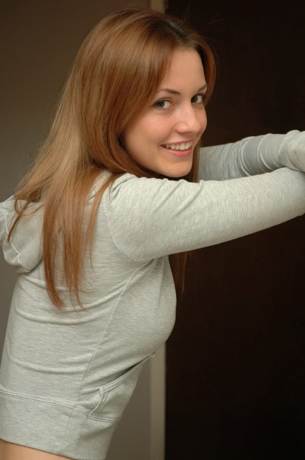 Amateur model with a pretty face poses non nude in denim jeans