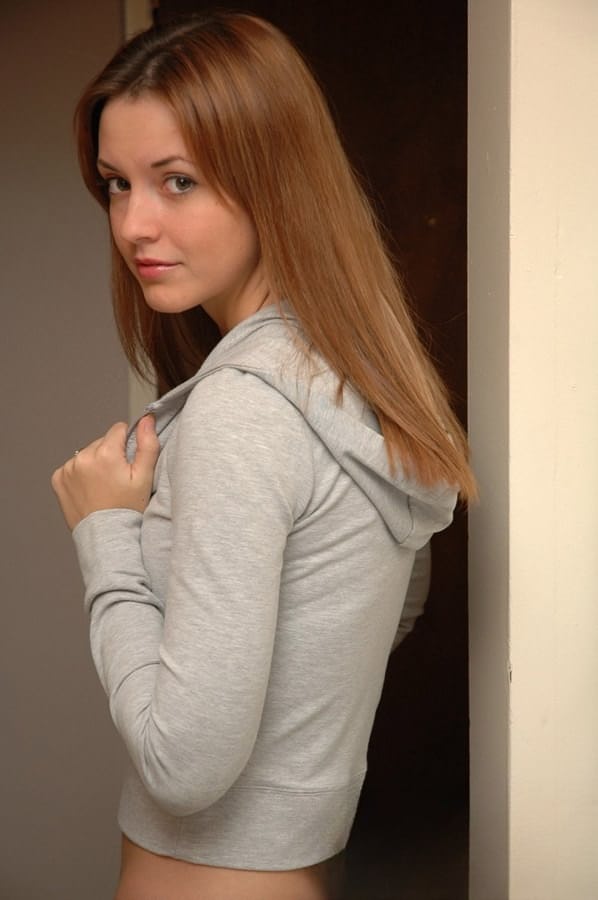 Amateur model with a pretty face poses non nude in denim jeans