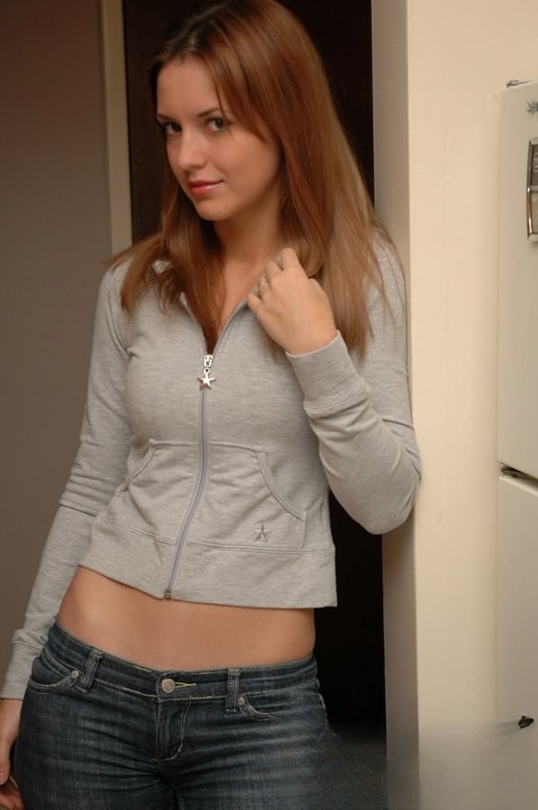 Amateur model with a pretty face poses non nude in denim jeans
