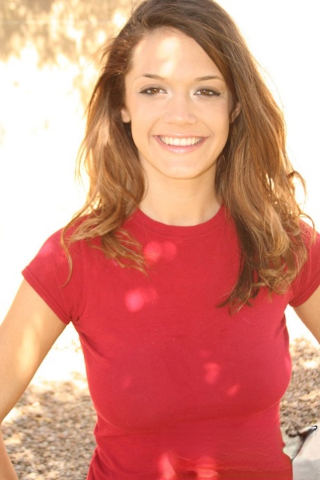 Teen amateur Brittany Maree places hands over her naked breasts while outdoors