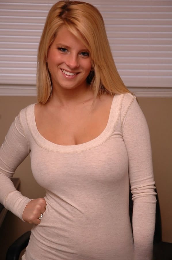 Young blonde girl reveals her bare ass cheeks in thong panties