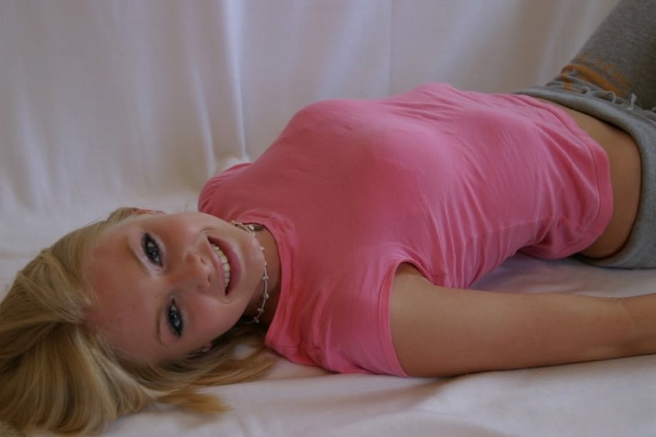 Cute teen girl Skye Model hangs out in a pink shirt and her yoga pants