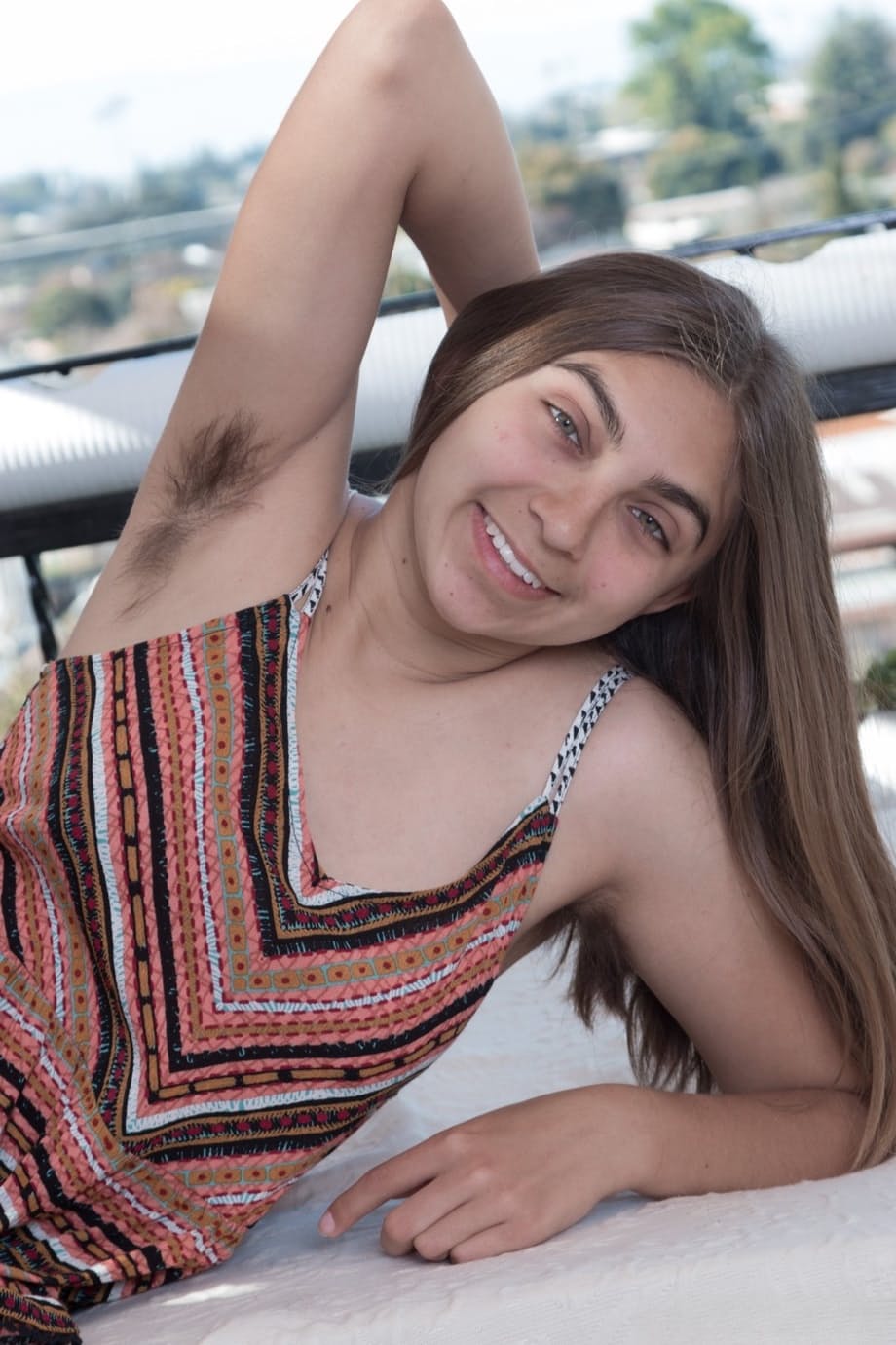 Amateur teenager Sunny displays her hairy armpits and bush out on the balcony