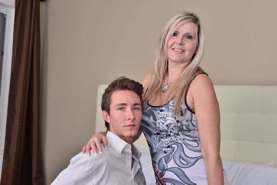 Middle aged woman shows her neighbor's boy the ways of sex in her bedroom