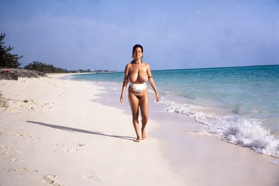 Busty MILF Devon Daniels gets her massive melons covered in sand at the beach