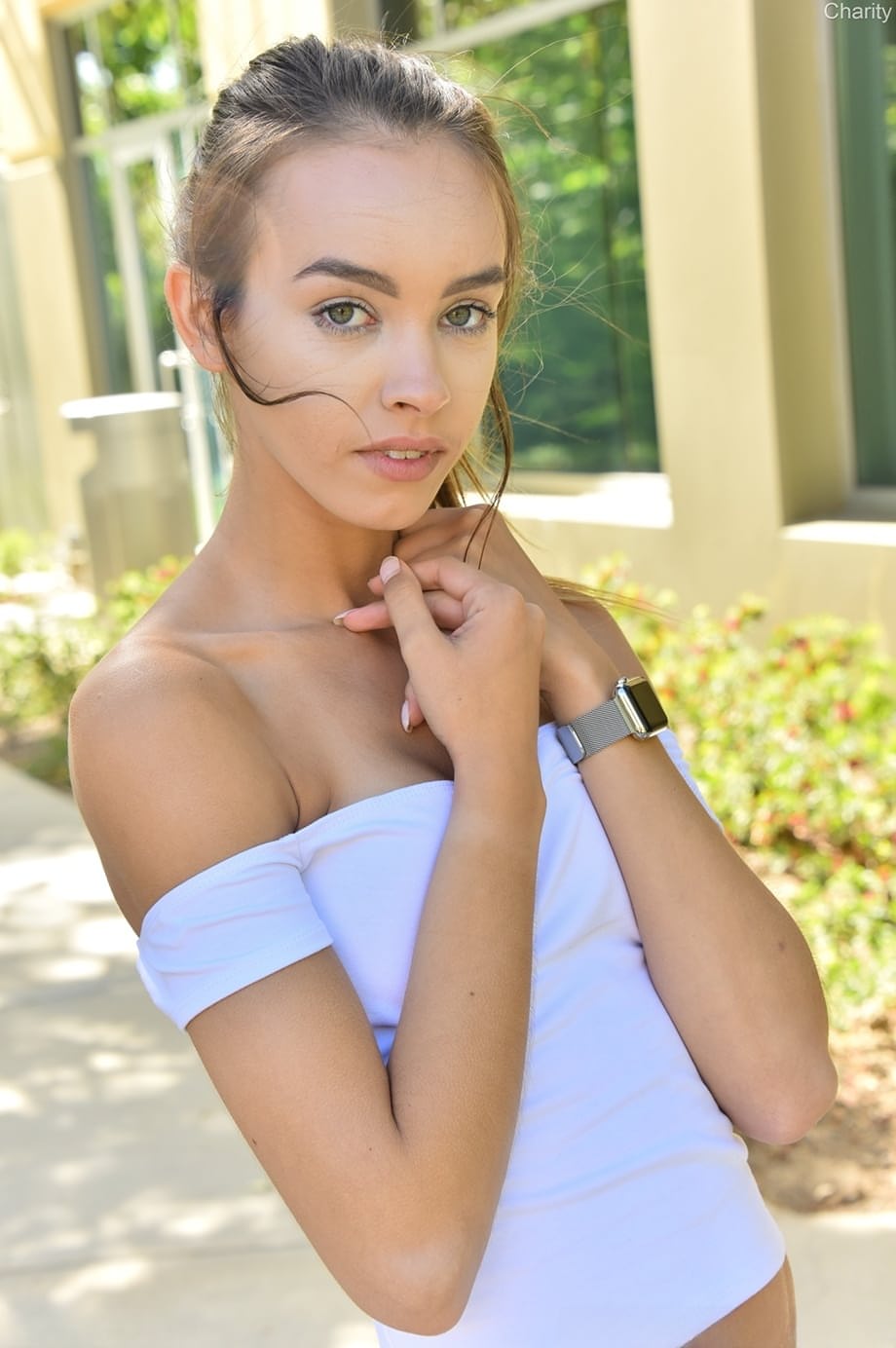 Cute solo girl Charity shows off her upskirt pussy outdoors with no panties on