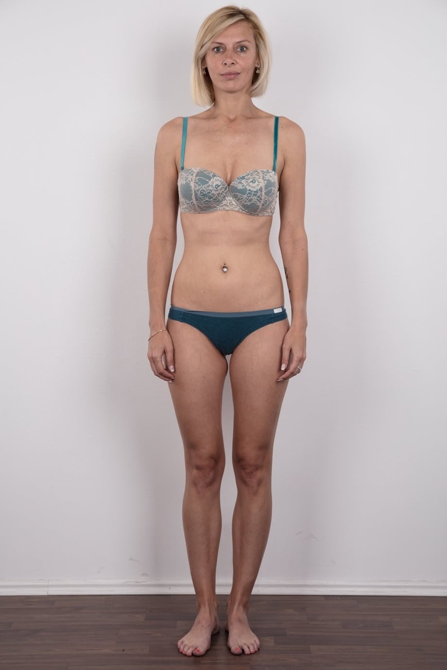 Freckle faced Zaneta takes off her short dress to reveal her slender naked bod