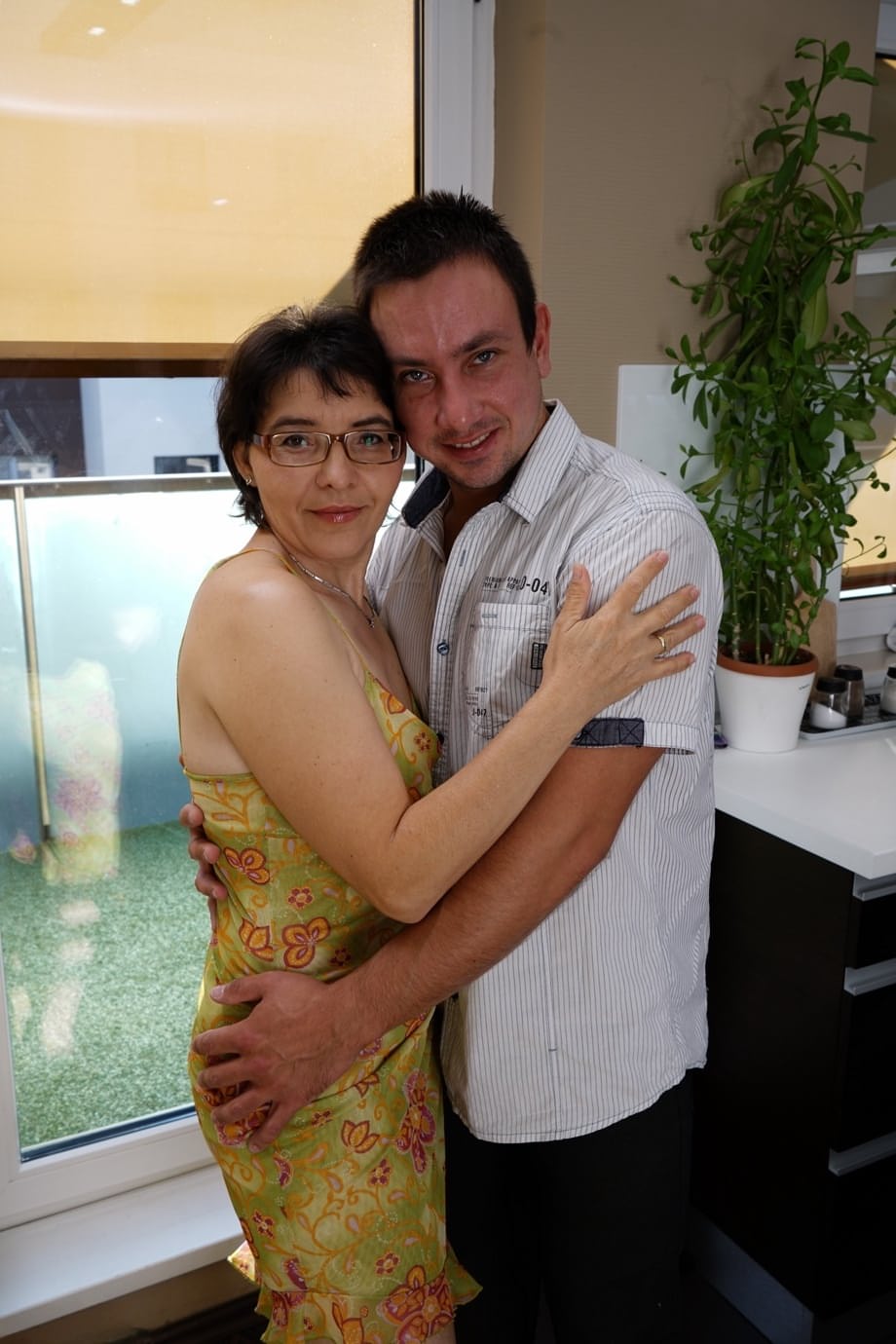 Older granny kissing and petting her toy boy and fucking in the kitchen