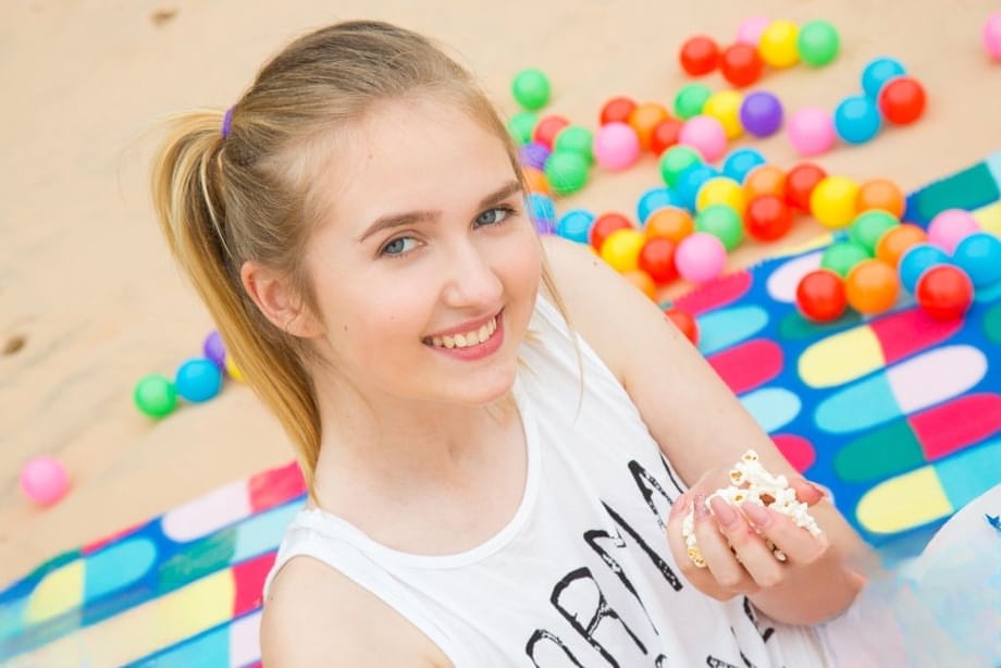 Barely legal teen reveals her flat chest and bald cunt on a beach blanket