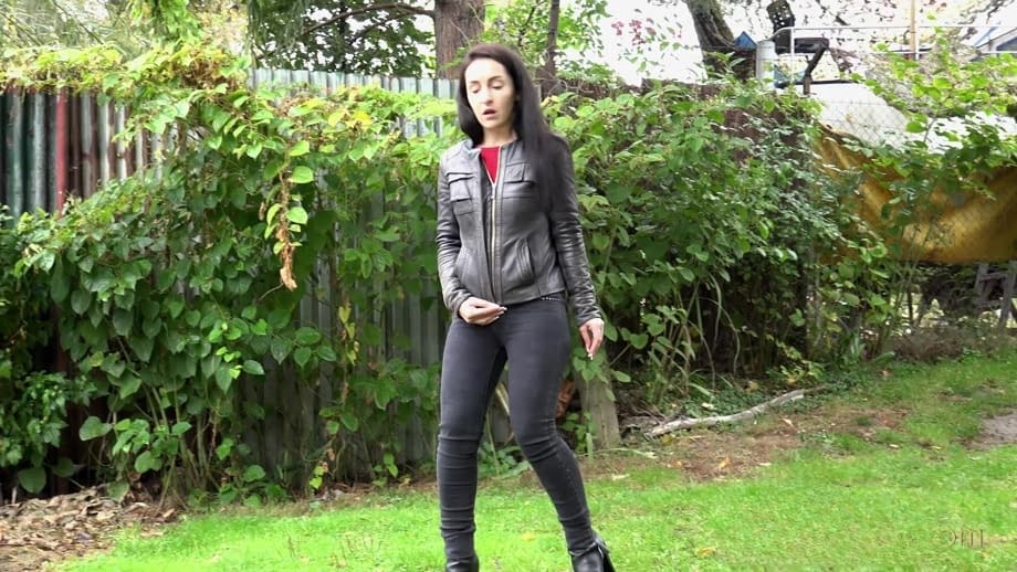 Long haired Corin bares her hairy pussy while taking a pee on the grass