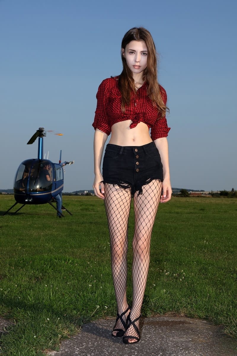Stunning teenage model Milla posing topless in fishnet pantyhose