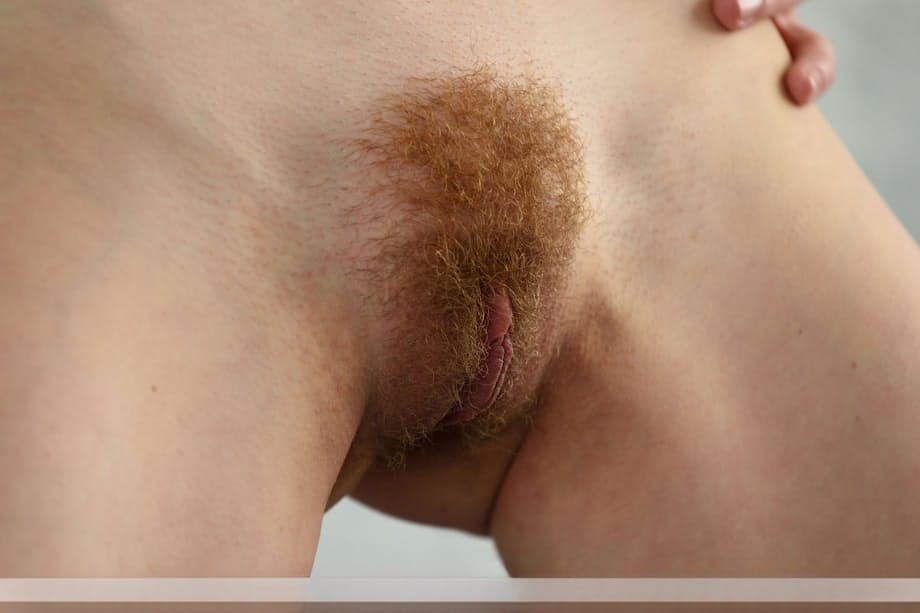 Beautiful redhead Adel P lounging naked showing off her hairy pussy close up
