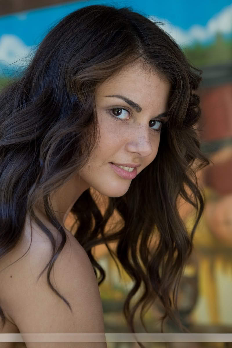 Sexy brunette with a landing strip pussy shows off her amazing ass in the nude
