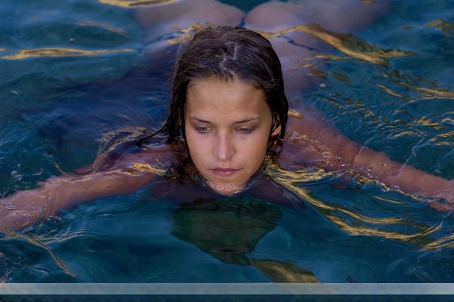 Naked teen Simona sinks to her neck in crystal clear water