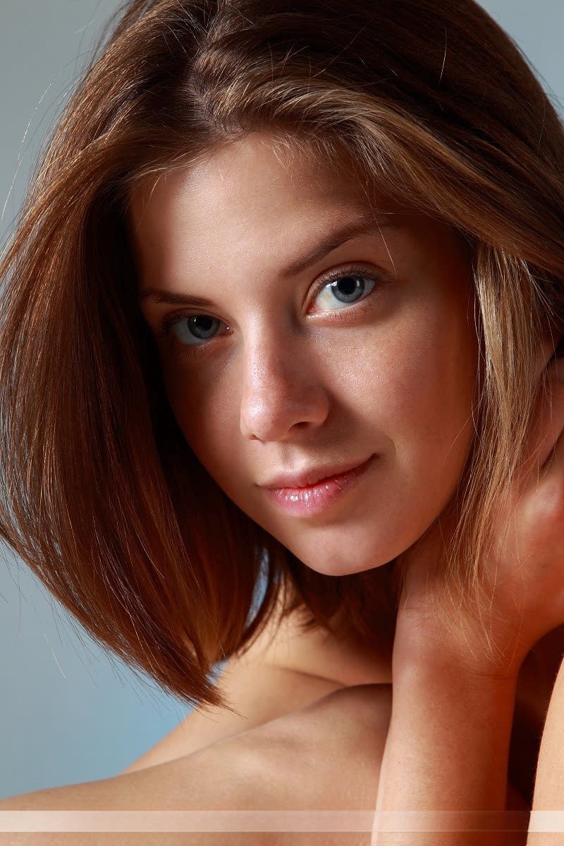 Sexy adorable Danica disrobes to crawl on the couch naked on her knees