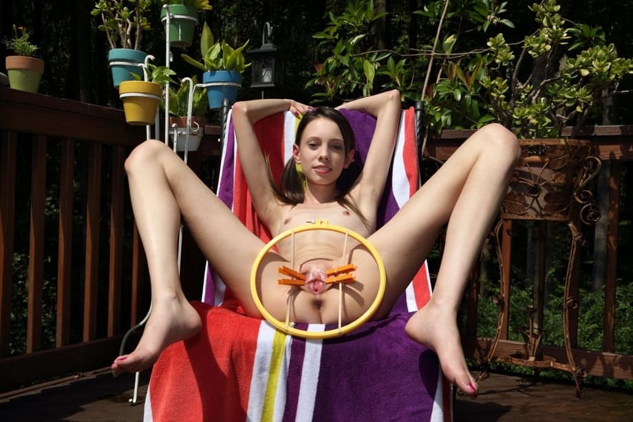 Skinny teen girl Aria Haze takes off her bikini and pegs her twat on patio