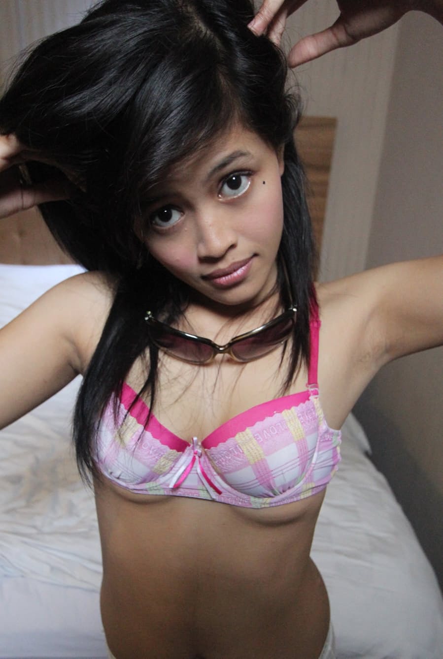 Indonesian teen strips naked on her bed to the delight of a sex tourist