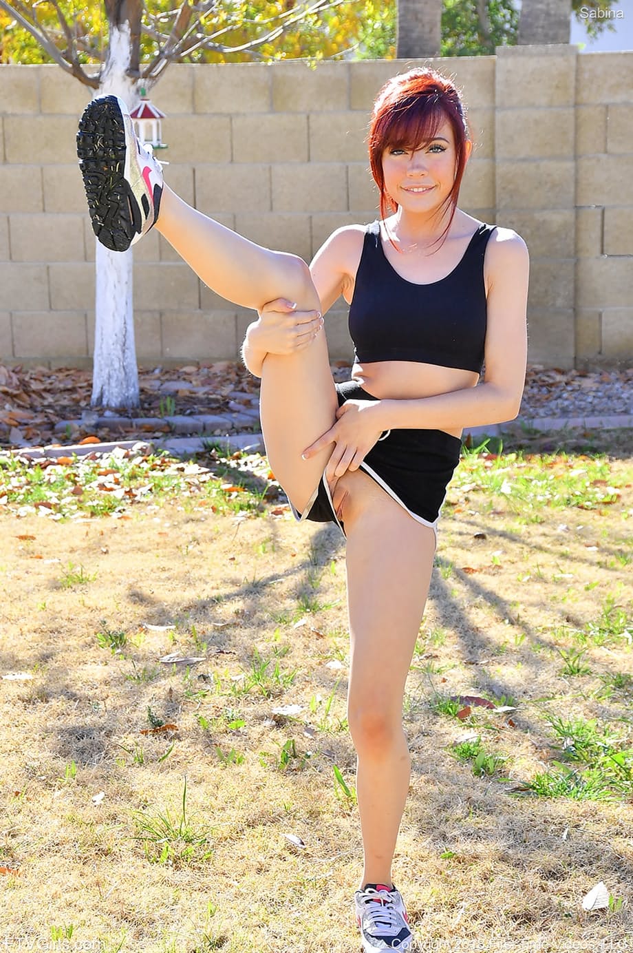 Athletic chick takes off her shorts and sports bra to do yoga in the nude