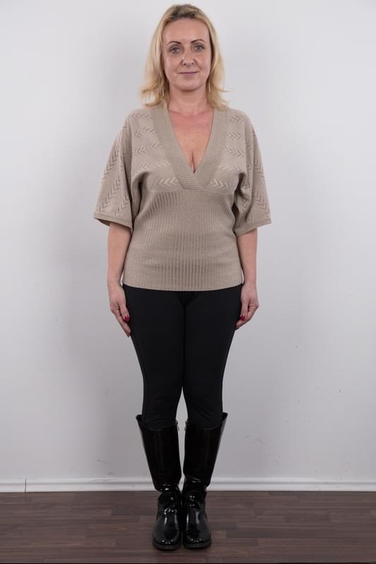 Middle-aged blonde lady Gerlinda stands totally nude after disrobing
