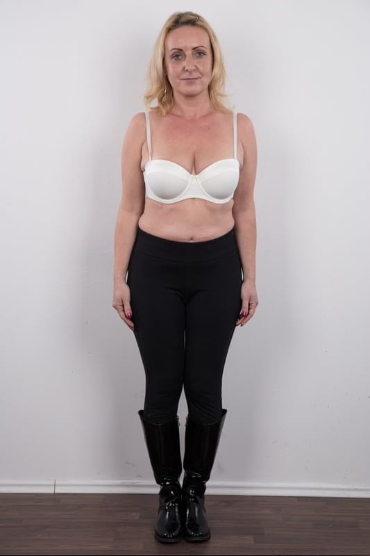 Middle-aged blonde lady Gerlinda stands totally nude after disrobing